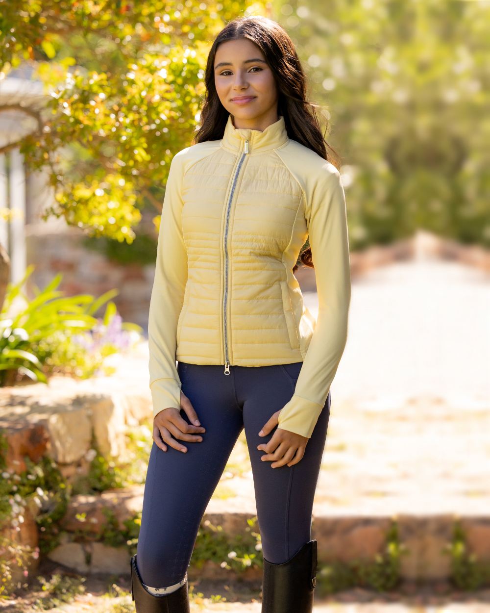 Mimosa coloured LeMieux Young Rider Josephine Jacket on backyard background 