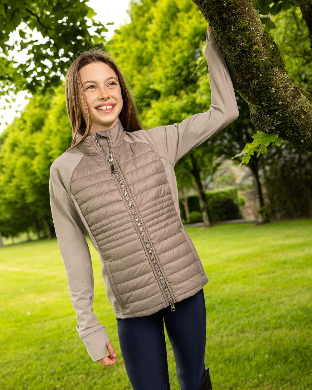 Pecan coloured LeMieux Young Rider Josephine Jacket on lawn background 