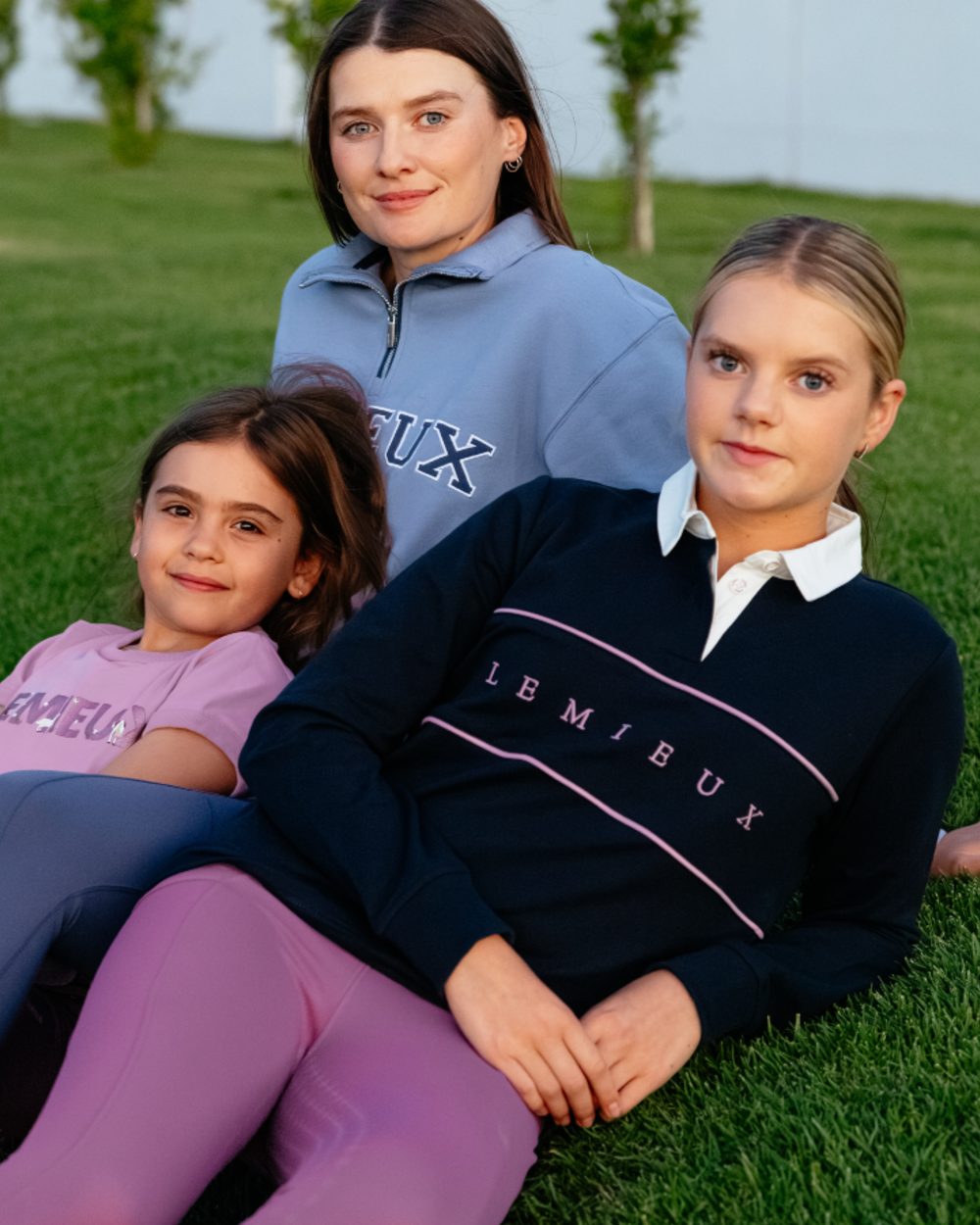 Navy coloured LeMieux Young Rider Riley Rugby Shirt on grass background 