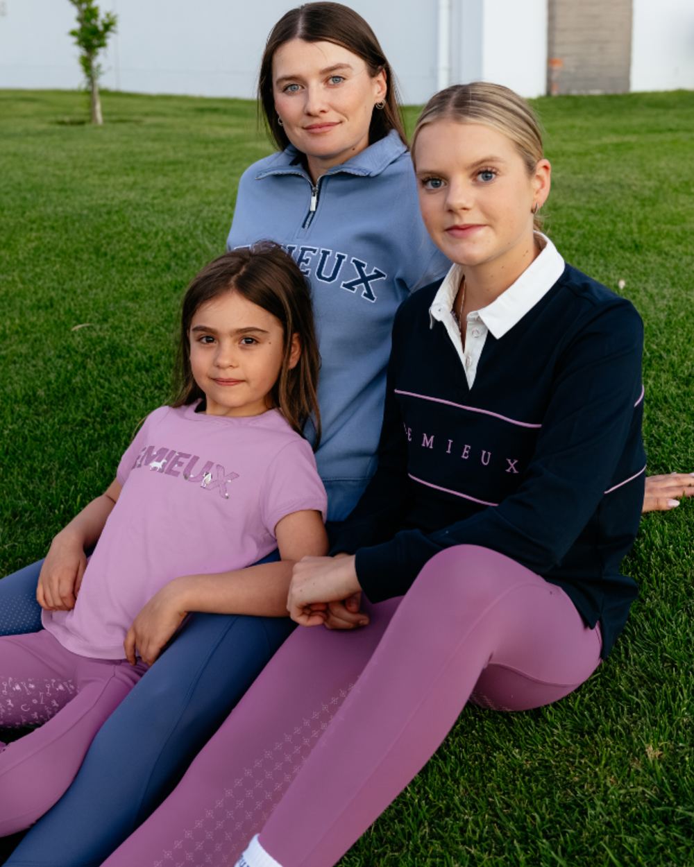 Navy coloured LeMieux Young Rider Riley Rugby Shirt on grass background 