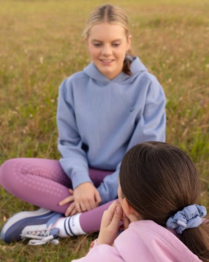 Powder Blue coloured LeMieux Young Rider Sia Hoodie on grass background 