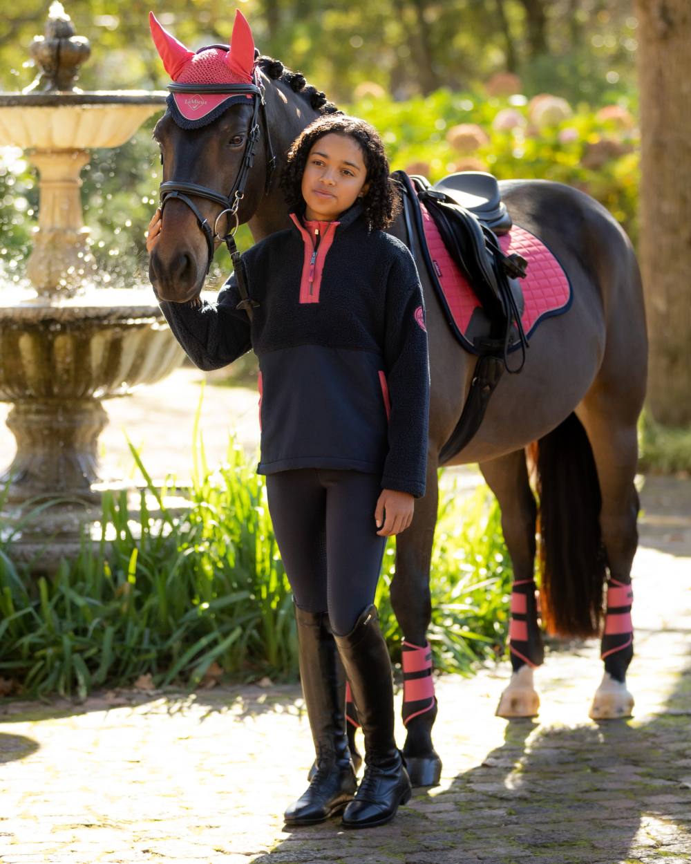 Navy coloured LeMieux Young Rider Tammy Teddy Fleece on garden background 