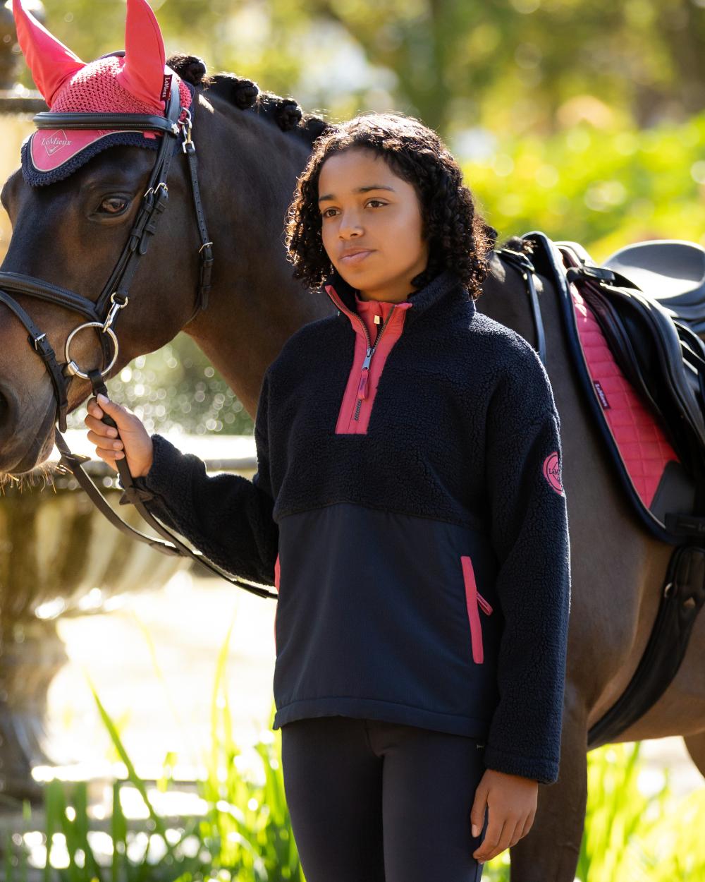 Navy coloured LeMieux Young Rider Tammy Teddy Fleece on garden background 