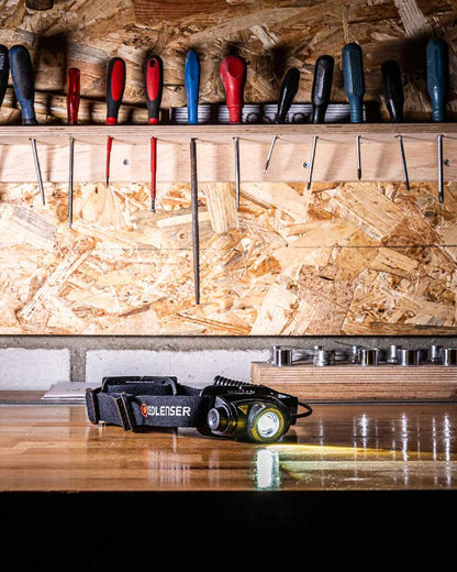 Black Coloured Led Lenser H5R Core Head Torch on wooden table background 