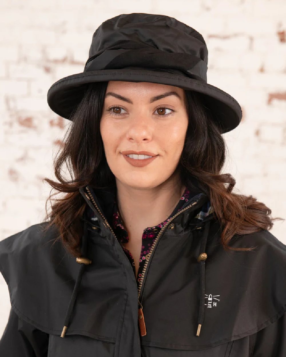 Black coloured Lighthouse Canterbury Waterproof Hat on wall background 