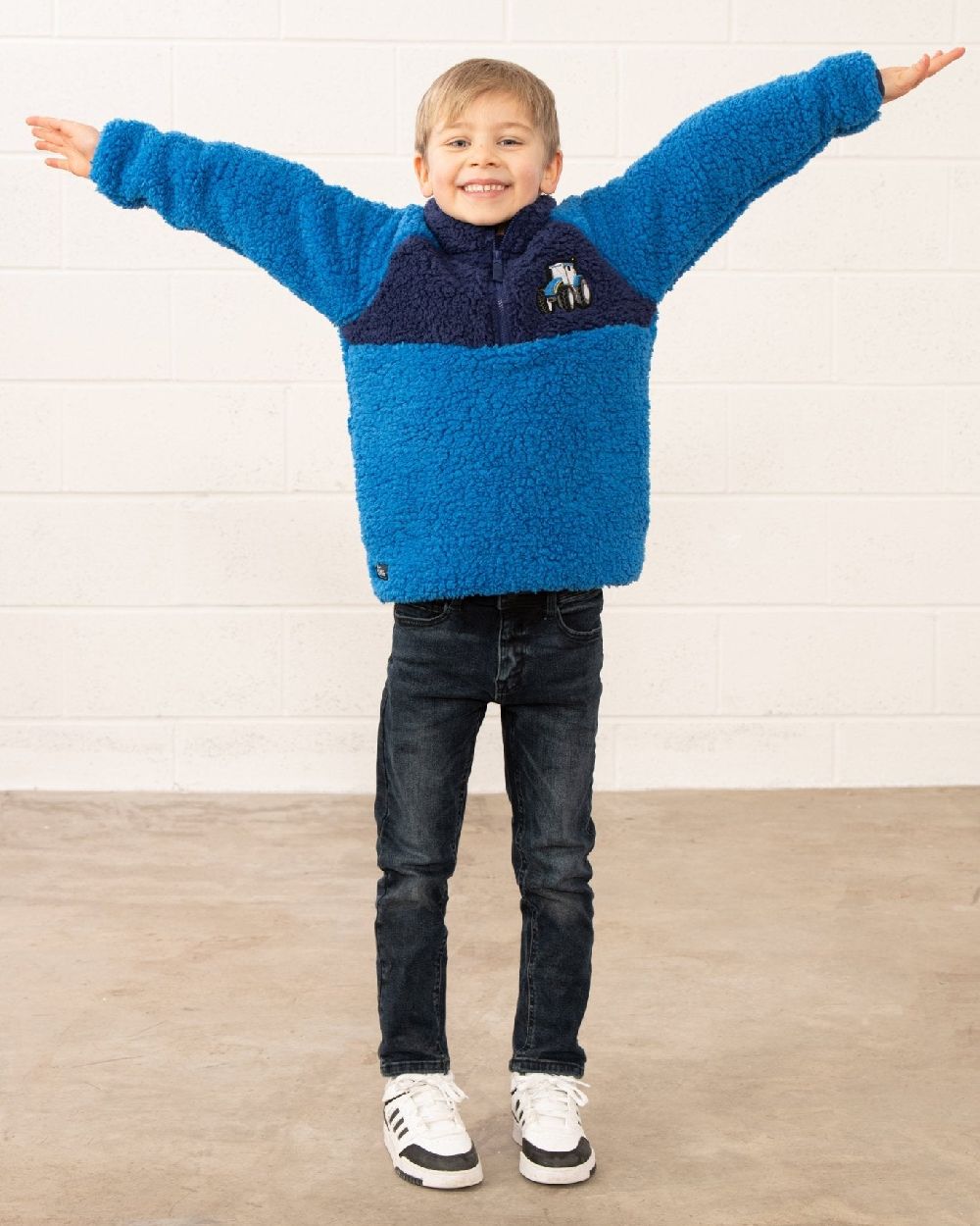 Blue Tractor coloured Lighthouse Childrens Caden Fleece on wall background 