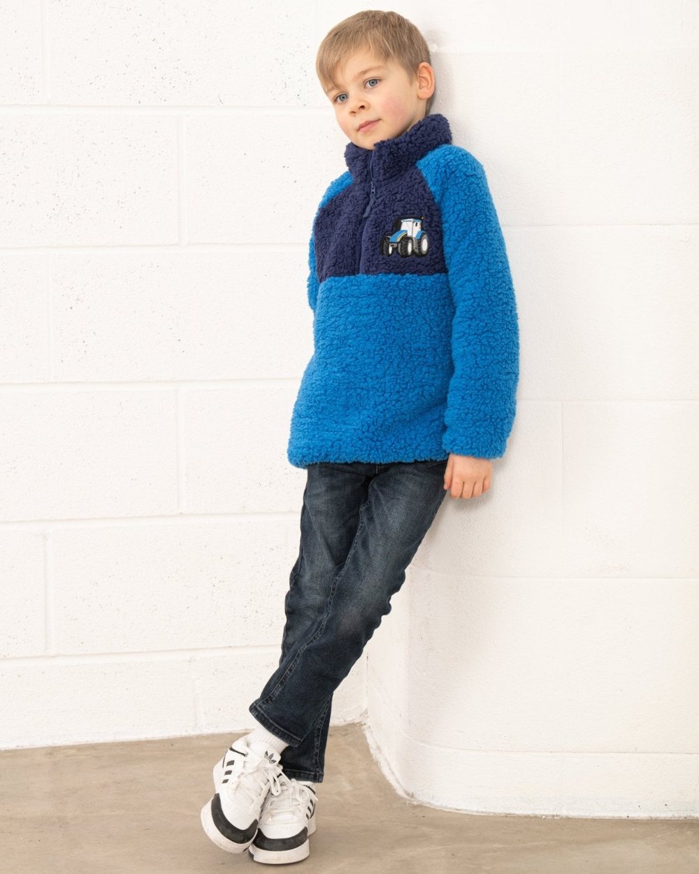 Blue Tractor coloured Lighthouse Childrens Caden Fleece on wall background 