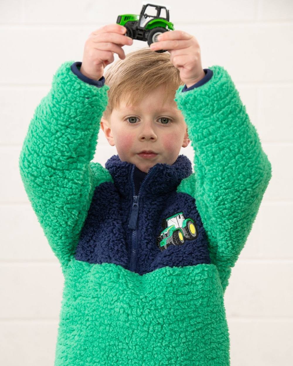 Green Tractor coloured Lighthouse Childrens Caden Fleece on wall background 