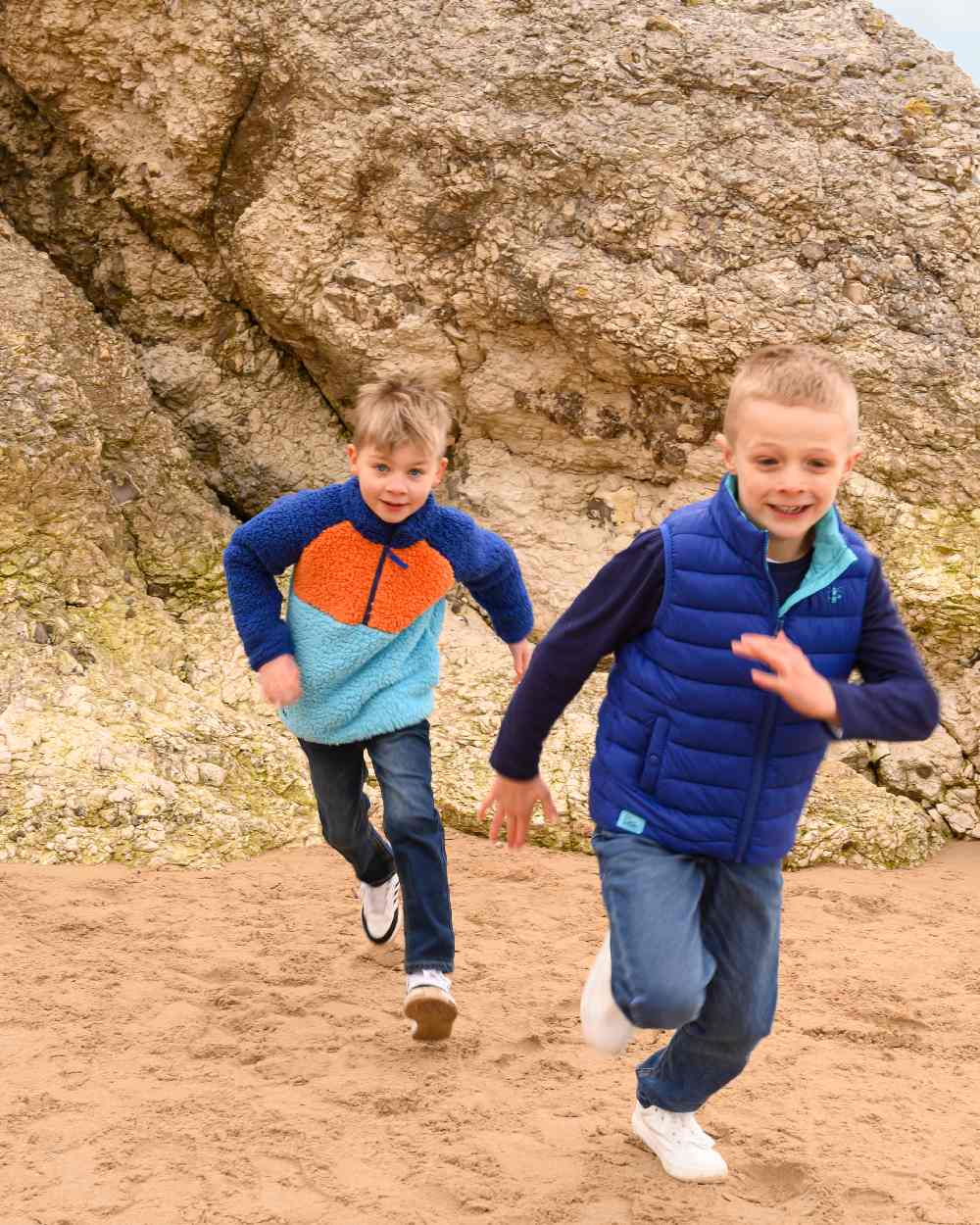 Navy Blue Orange coloured Lighthouse Childrens Caden Fleece on beach background 