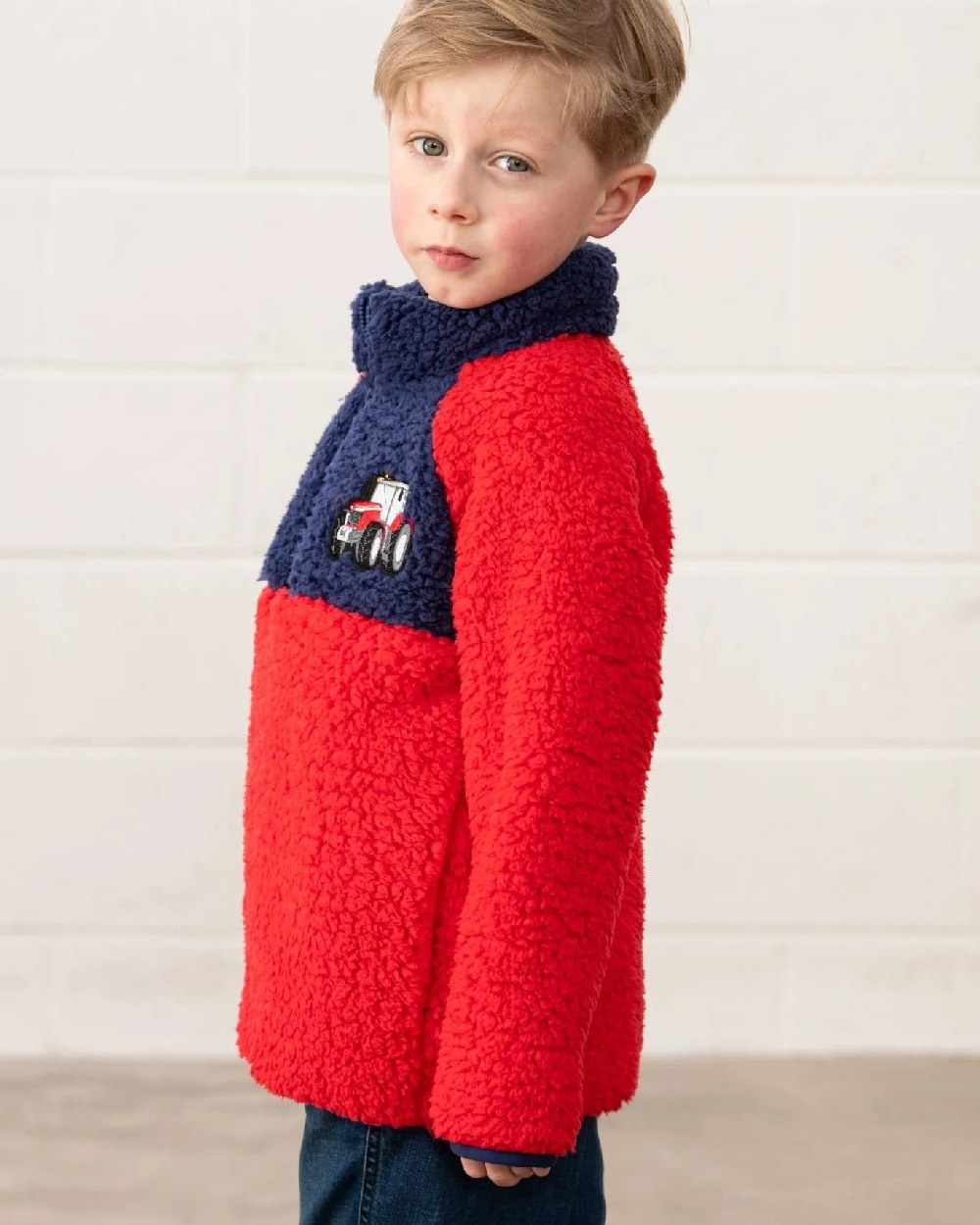 Red Tractor coloured Lighthouse Childrens Caden Fleece on wall background 