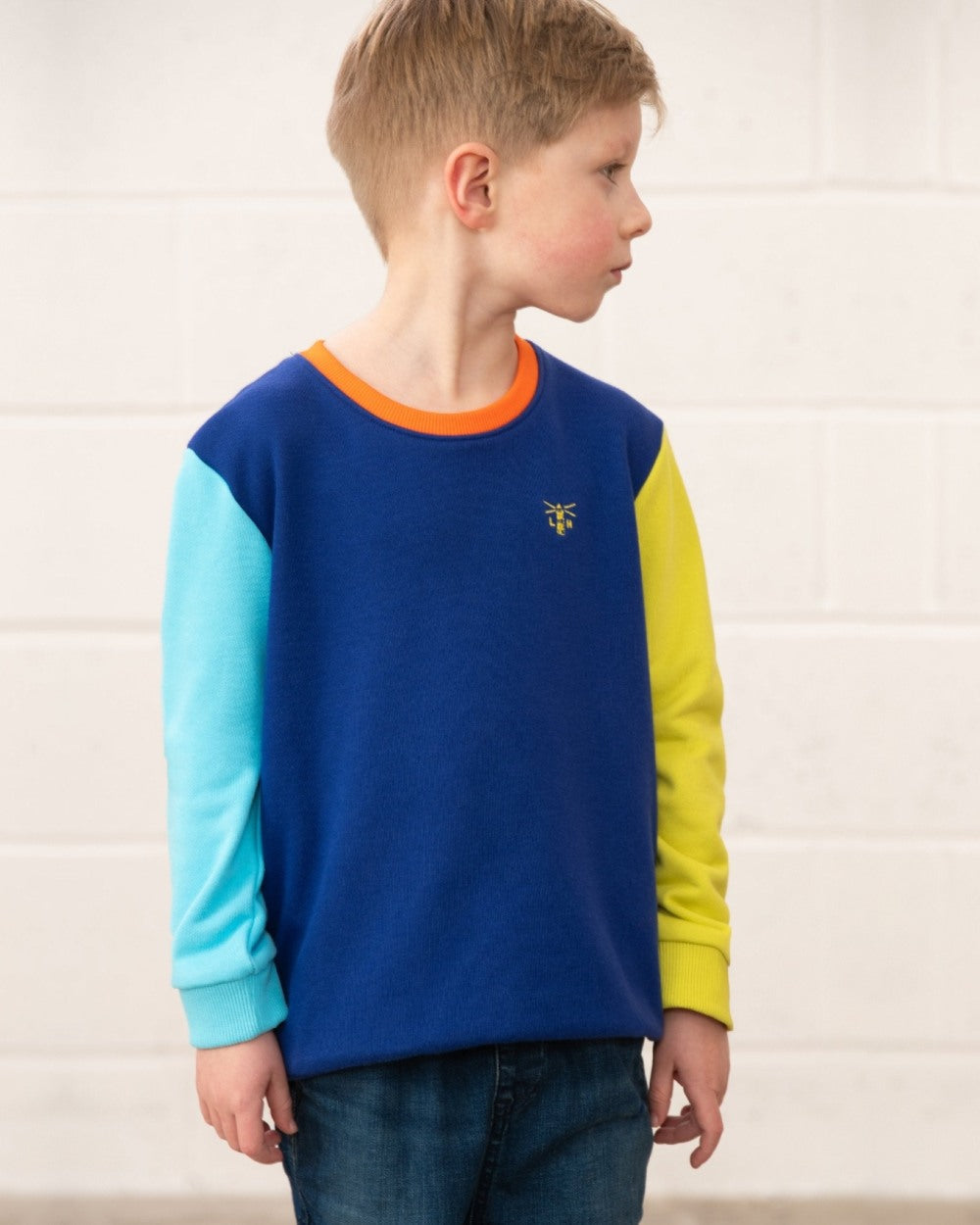 Blue Navy Lime coloured Lighthouse Childrens Finn Jersey on wall background 