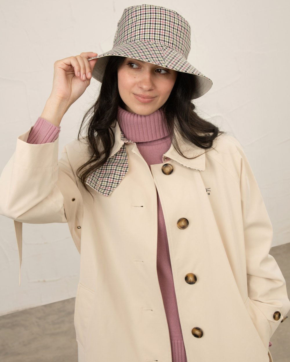 Stone coloured Lighthouse Edie Reversible Rain Hat on wall background 