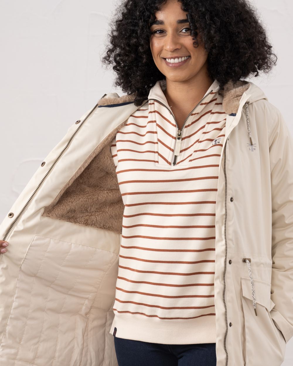 Irish Cream coloured Lighthouse Isobel Ladies Coat on wall background 