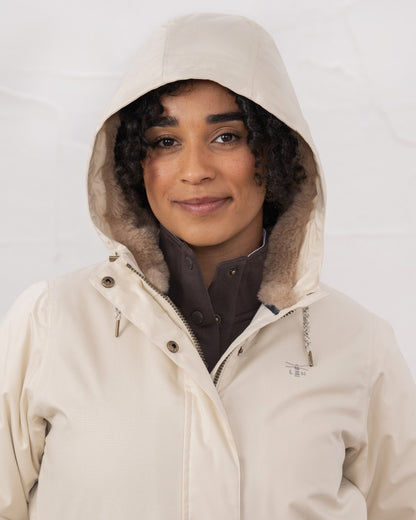 Irish Cream coloured Lighthouse Isobel Ladies Coat on wall background 