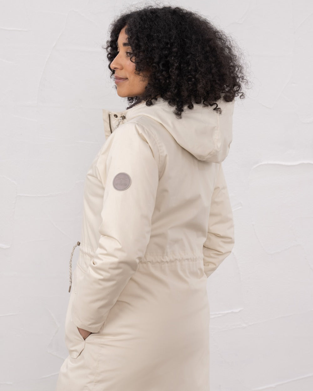 Irish Cream coloured Lighthouse Isobel Ladies Coat on wall background 