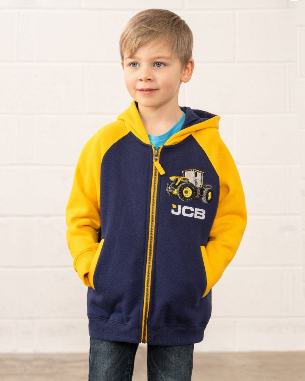 Navy JCB coloured Lighthouse Jackson Childrens Full Zip Hoodie on wall background 