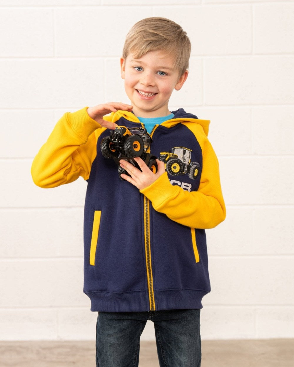 Navy JCB coloured Lighthouse Jackson Childrens Full Zip Hoodie on wall background 