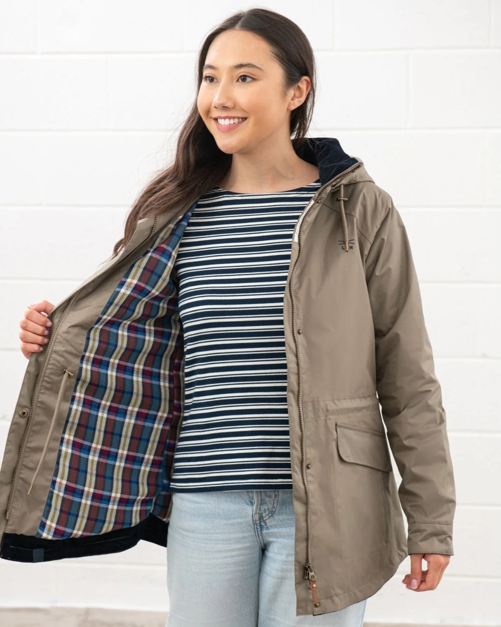 Fawn coloured Lighthouse Kendal Waterproof Coat on white wall background 