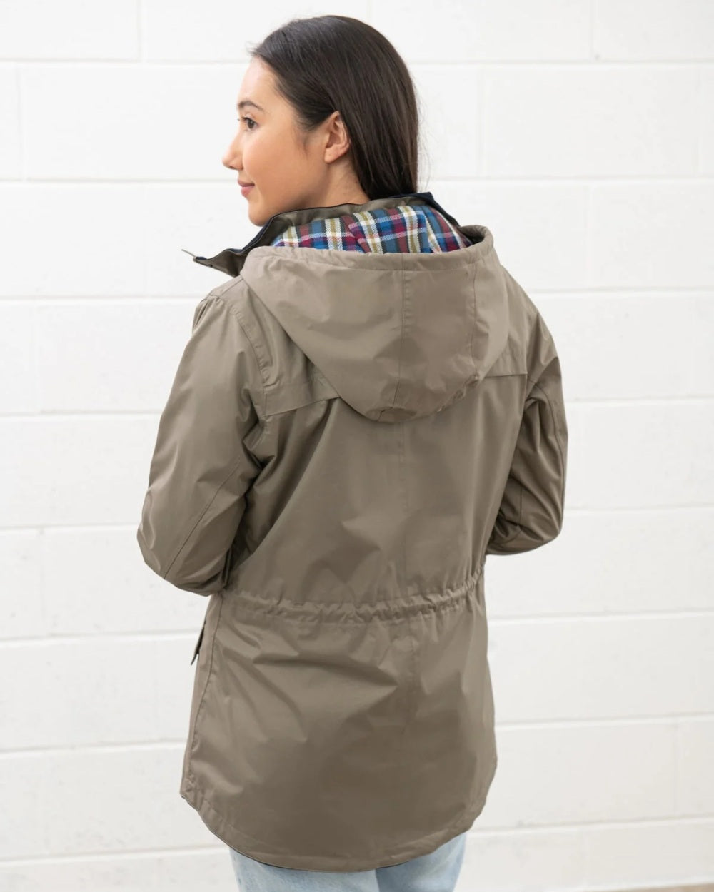 Fawn coloured Lighthouse Kendal Waterproof Coat on white wall background 