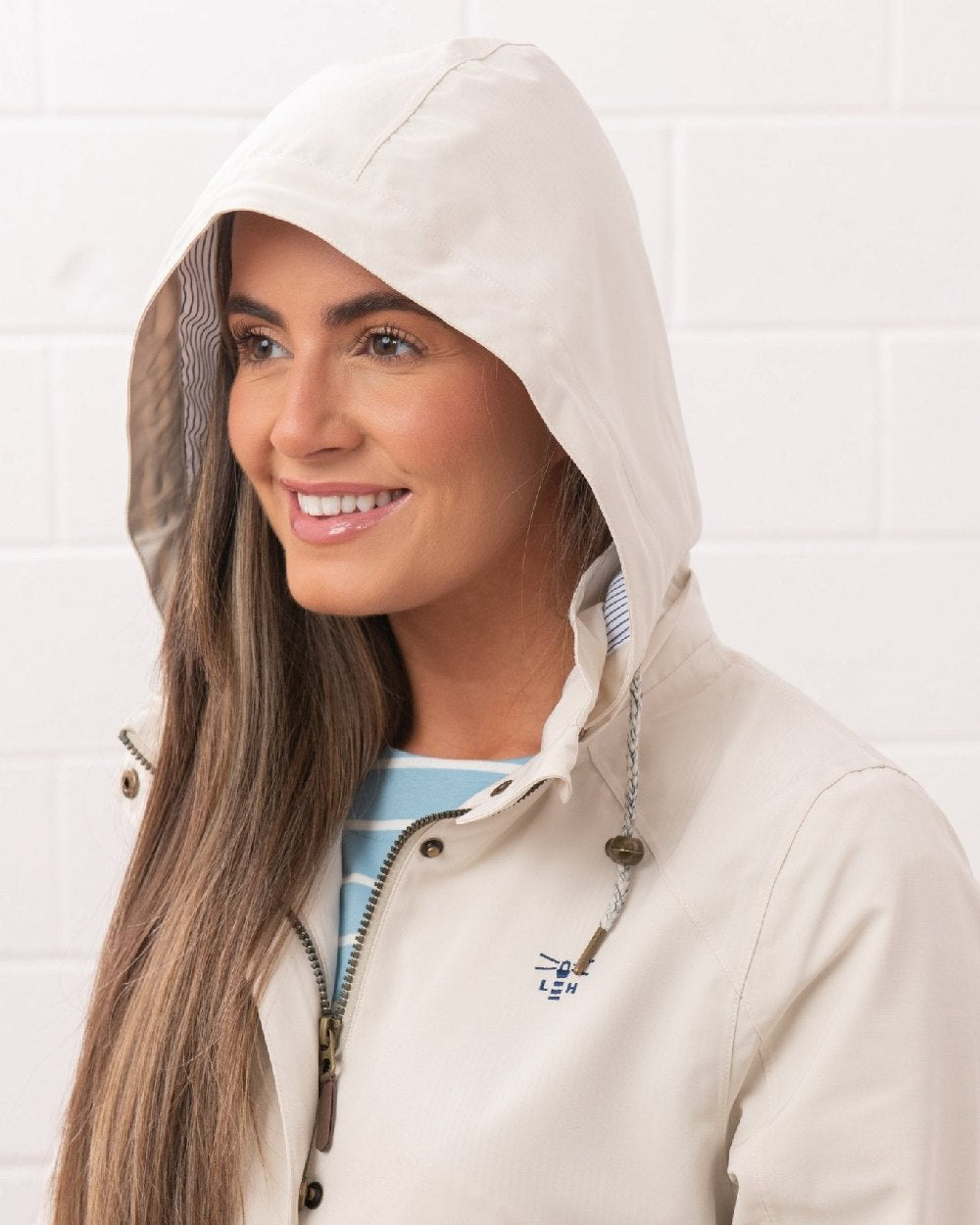 Cream coloured Lighthouse Ladies Annika Coat on wall background 
