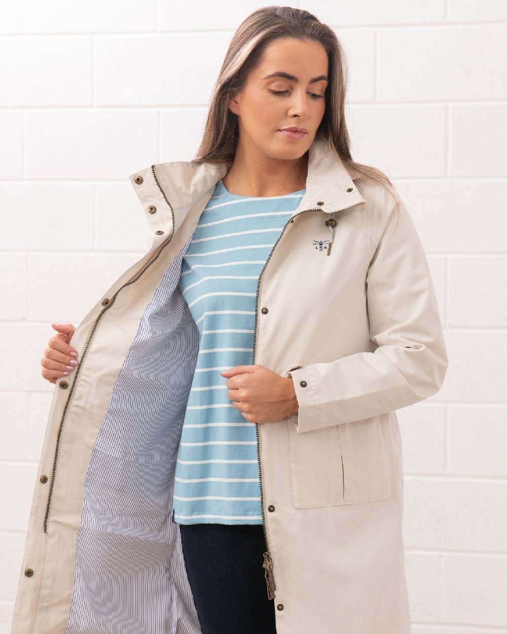 Cream coloured Lighthouse Ladies Annika Coat on wall background 