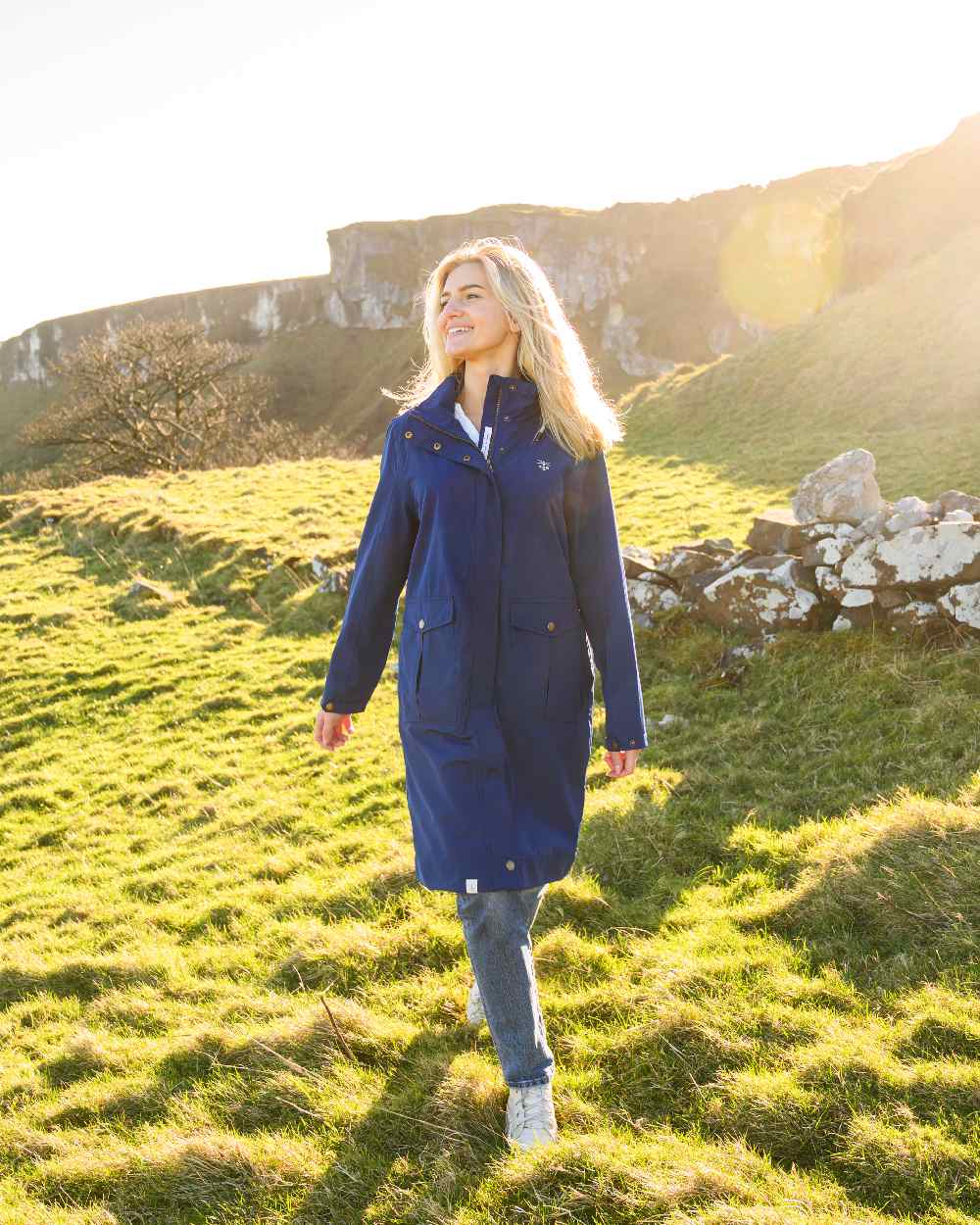 Indigo coloured Lighthouse Ladies Annika Coat on meadow background 