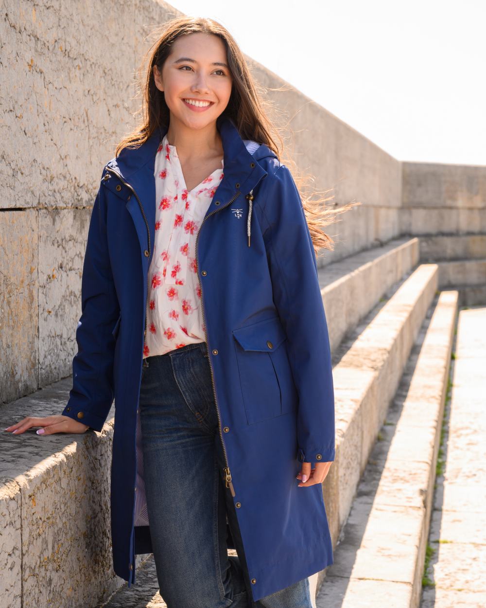 Indigo coloured Lighthouse Ladies Annika Coat on stairs background 