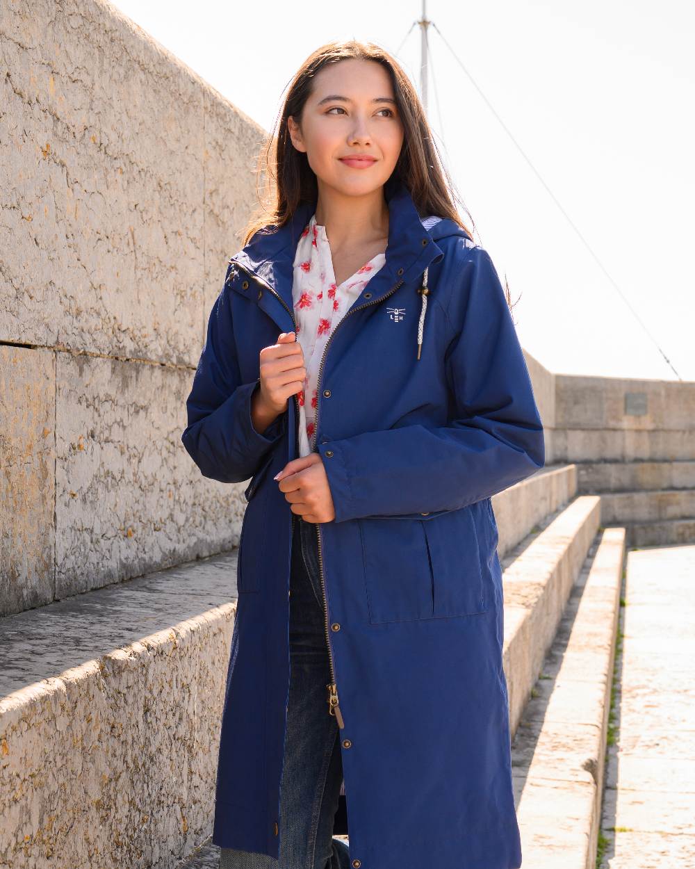 Indigo coloured Lighthouse Ladies Annika Coat on stairs background 