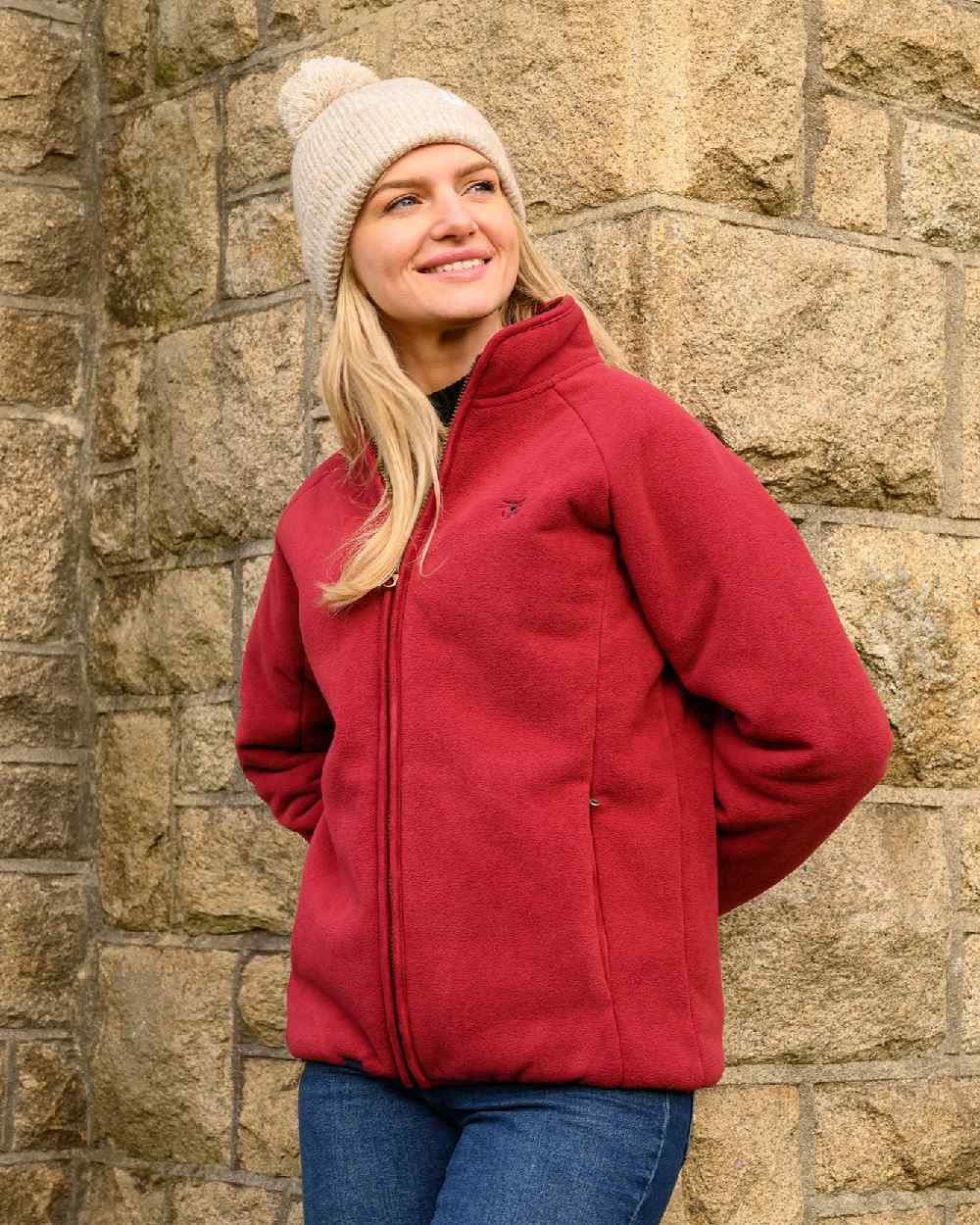 Maroon coloured Lighthouse Ladies Avon Waterproof Fleece on wall background 