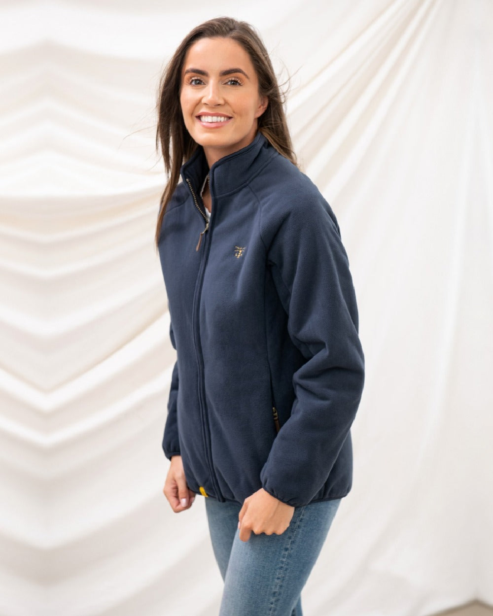 Navy coloured Lighthouse Ladies Avon Waterproof Fleece on curtain background 