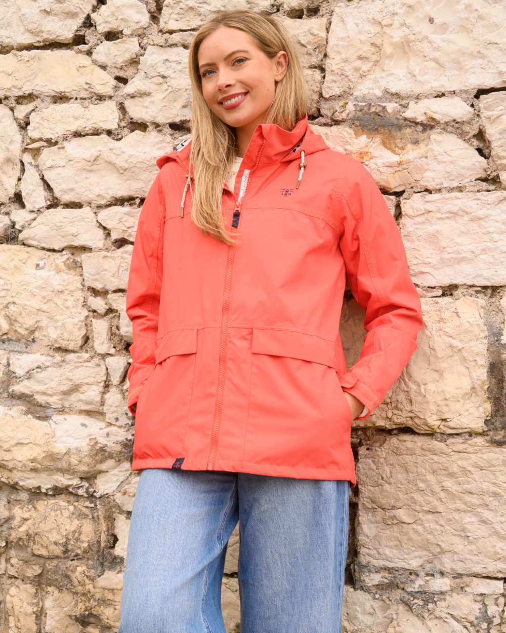 Coral coloured Lighthouse Ladies Beachcomber II Coat on outdoor background 