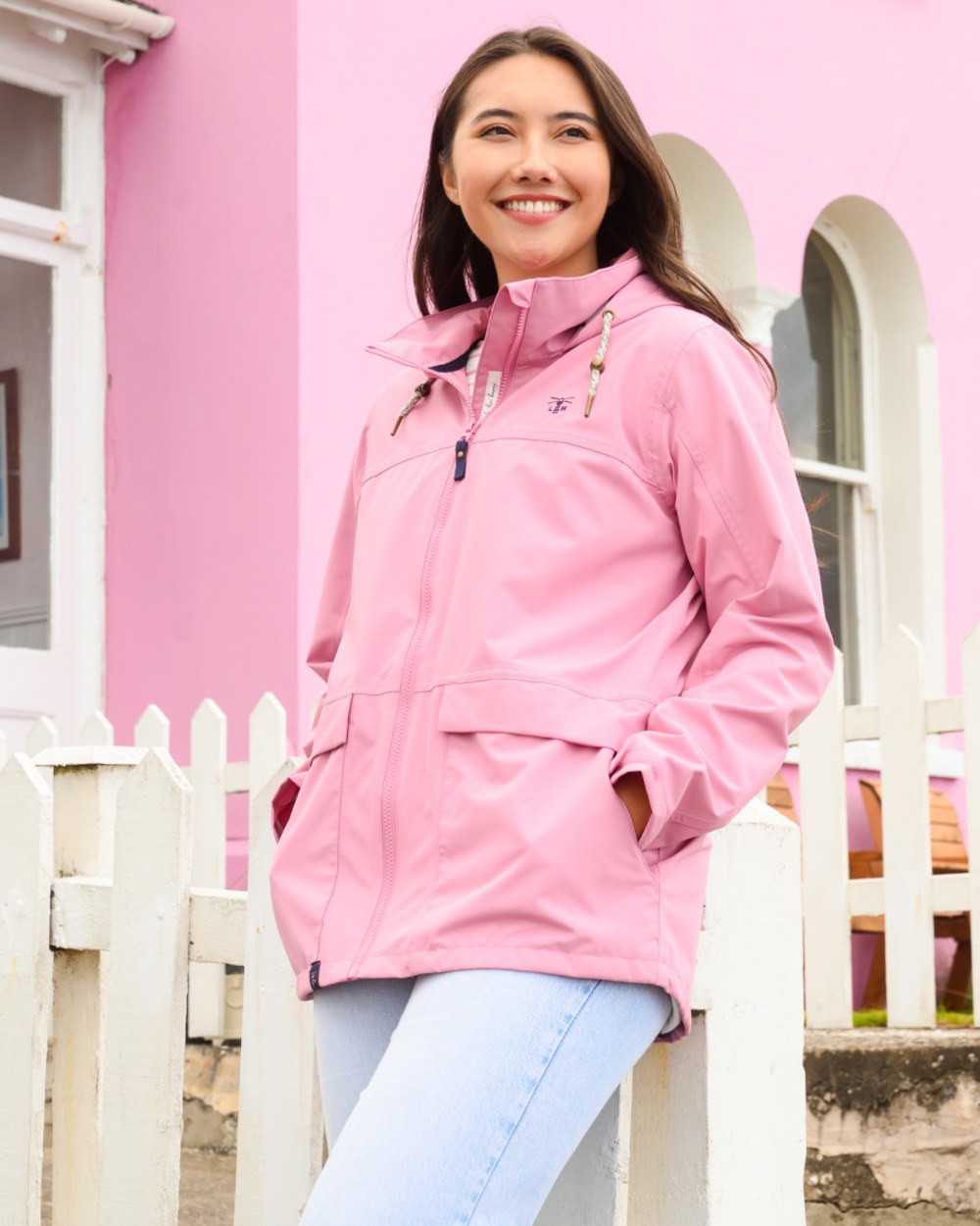 Pink coloured Lighthouse Ladies Beachcomber II Coat on outdoor background 