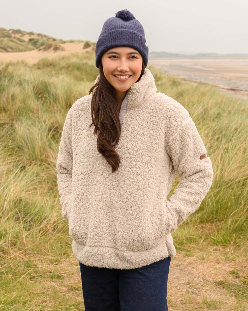 Irish Cream coloured Lighthouse Ladies Coast Half Zip Fleece Sweater on grassy background 