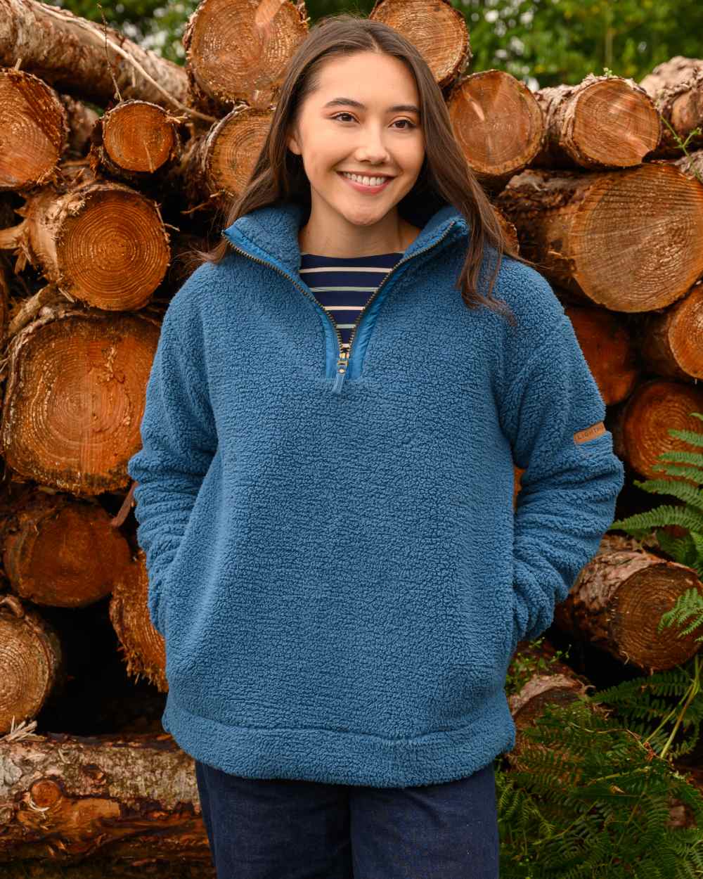 Teal coloured Lighthouse Ladies Coast Half Zip Fleece Sweater on wood background 