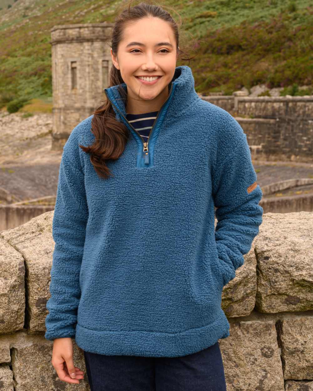 Teal coloured Lighthouse Ladies Coast Half Zip Fleece Sweater on outdoor background 