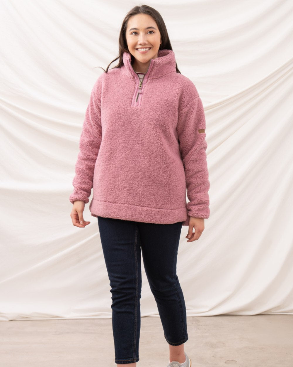 Wild Rose coloured Lighthouse Ladies Coast Half Zip Fleece Sweater on curtain background 