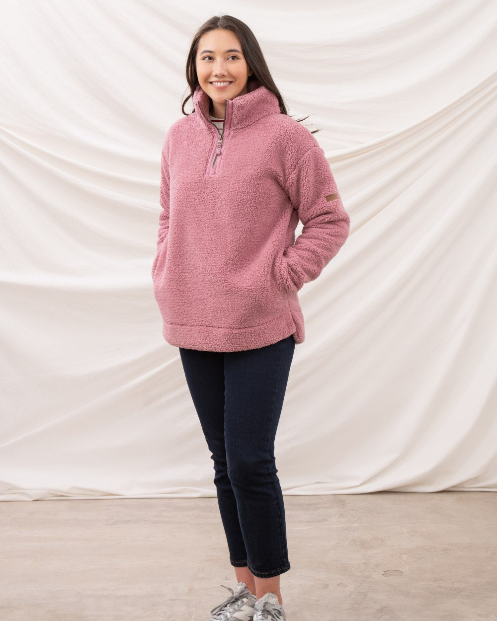 Wild Rose coloured Lighthouse Ladies Coast Half Zip Fleece Sweater on curtain background 