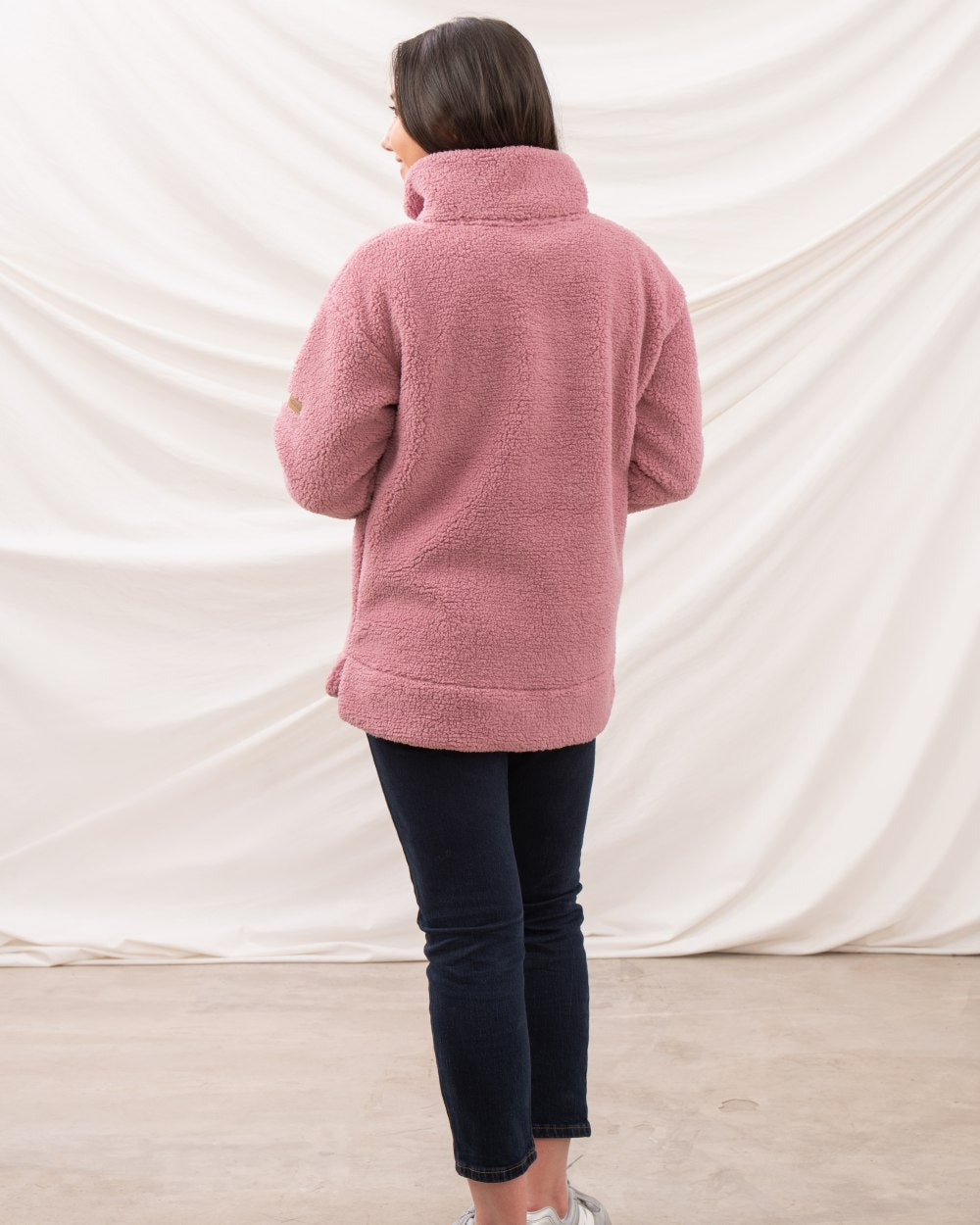 Wild Rose coloured Lighthouse Ladies Coast Half Zip Fleece Sweater on curtain background 