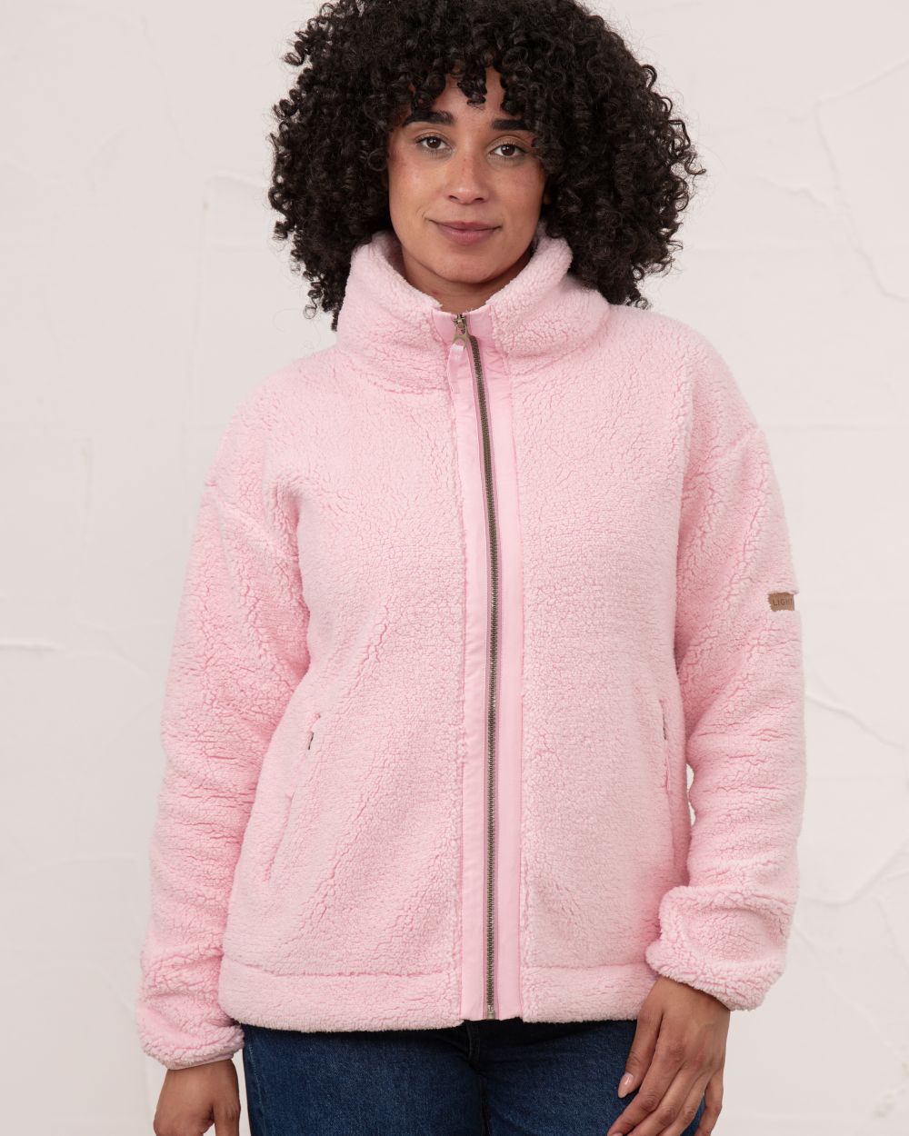 Pink coloured Lighthouse Ladies Cobh Full Zip Fleece Jacket on wall background 