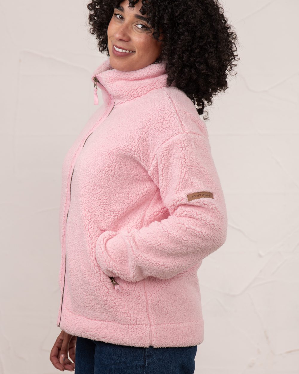 Pink coloured Lighthouse Ladies Cobh Full Zip Fleece Jacket on wall background 