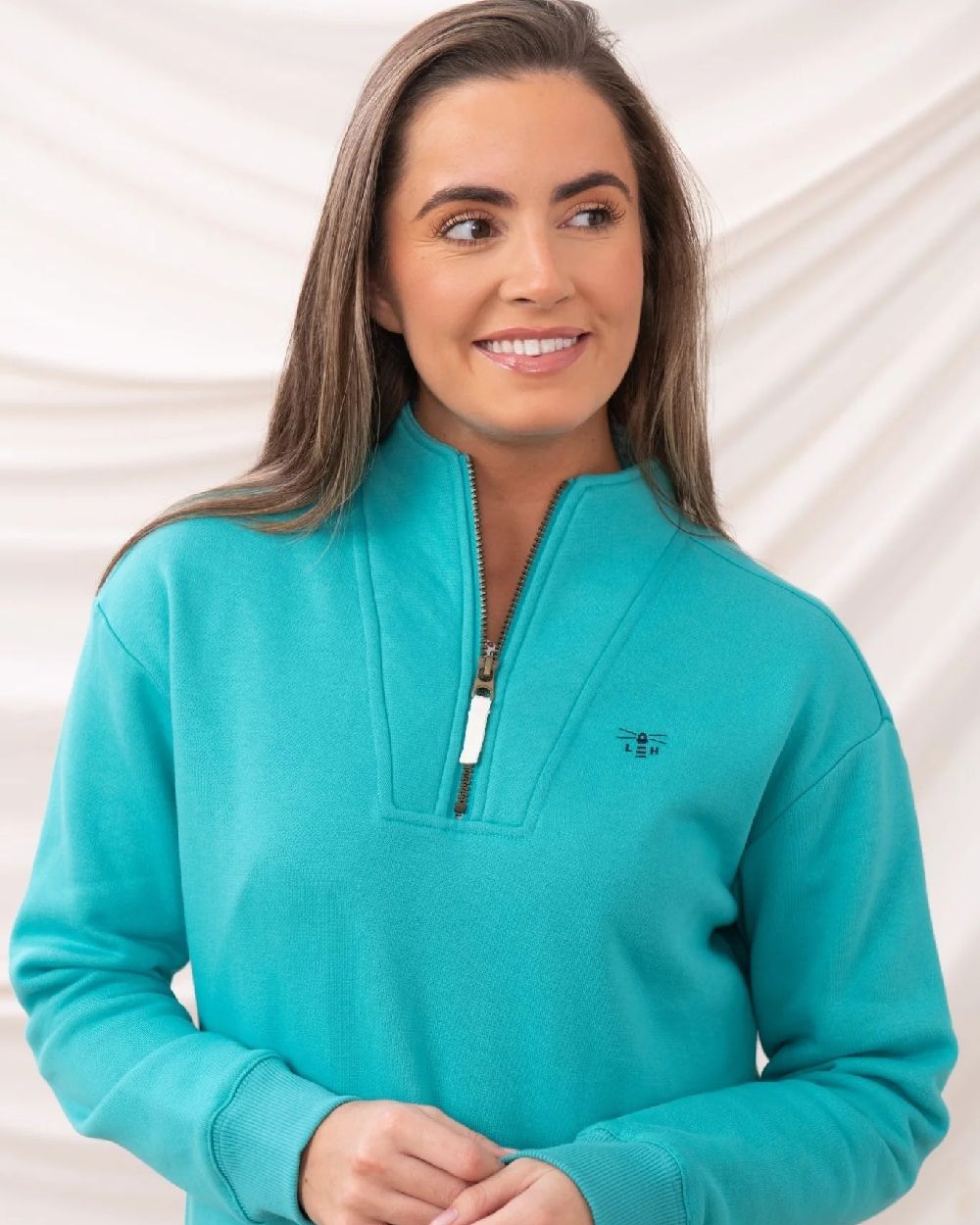 Soft Teal coloured Lighthouse Ladies Coral Jersey on curtain background 