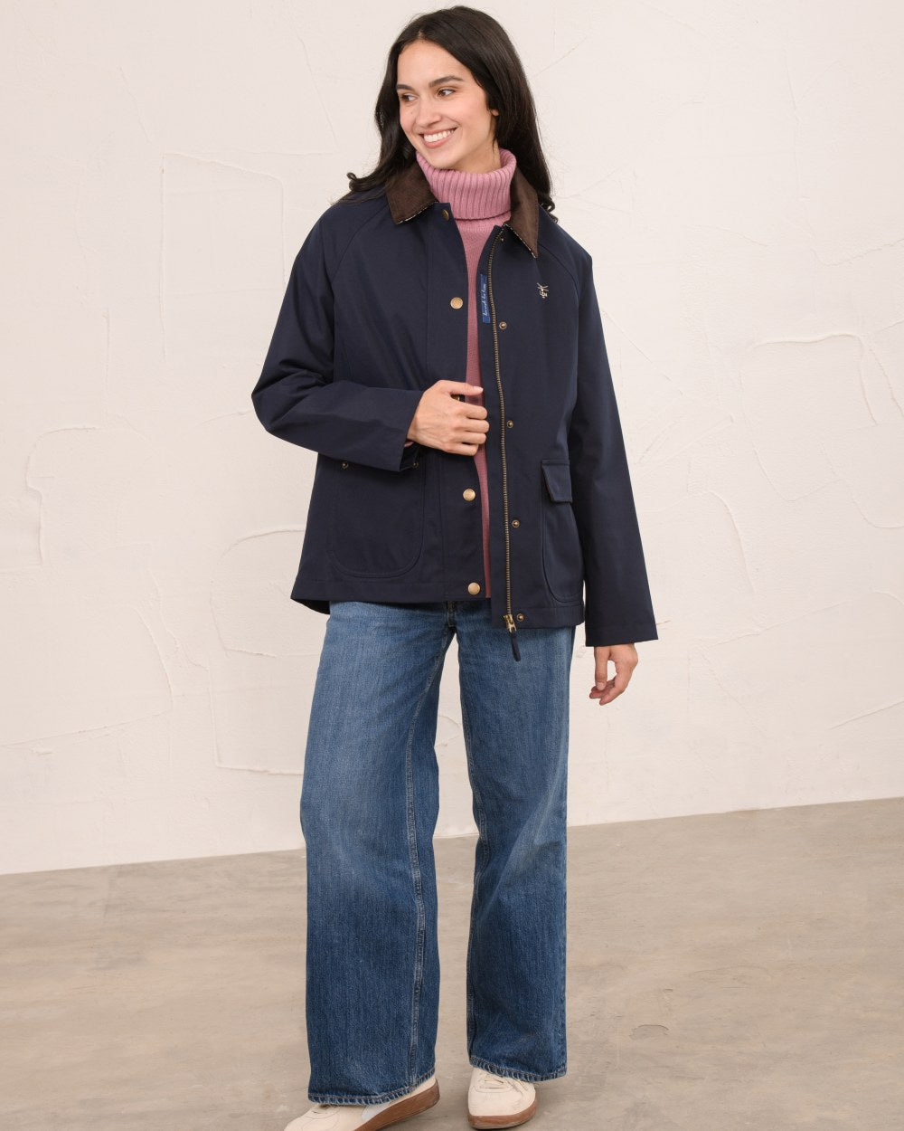 Navy coloured Lighthouse Ladies Devon Raincoat on indoor background 