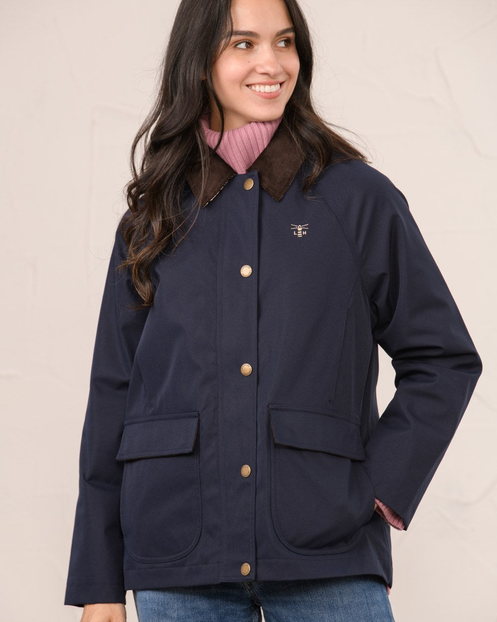 Navy coloured Lighthouse Ladies Devon Raincoat on indoor background 