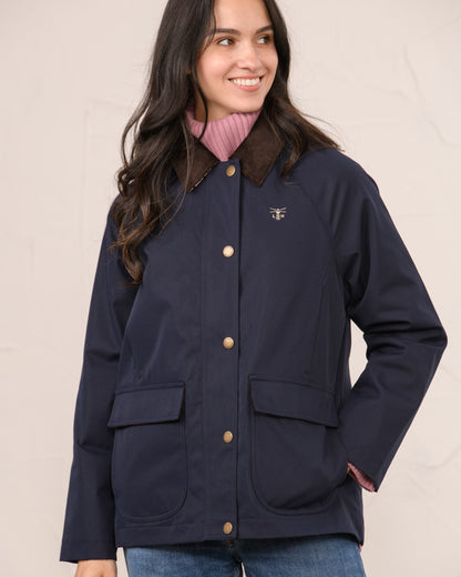 Navy coloured Lighthouse Ladies Devon Raincoat on indoor background 