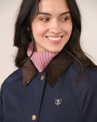 Navy coloured Lighthouse Ladies Devon Raincoat on indoor background 