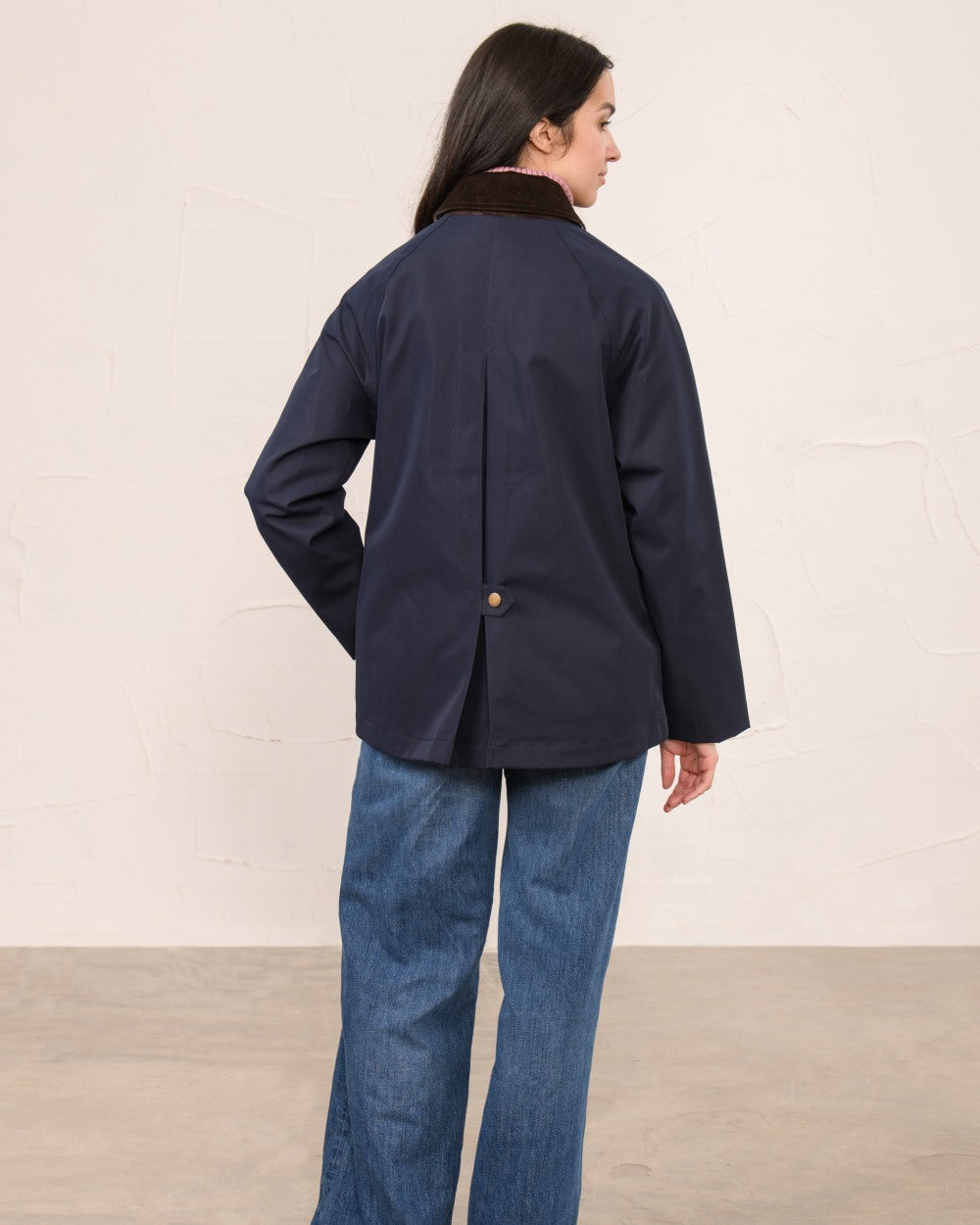 Navy coloured Lighthouse Ladies Devon Raincoat on indoor background 