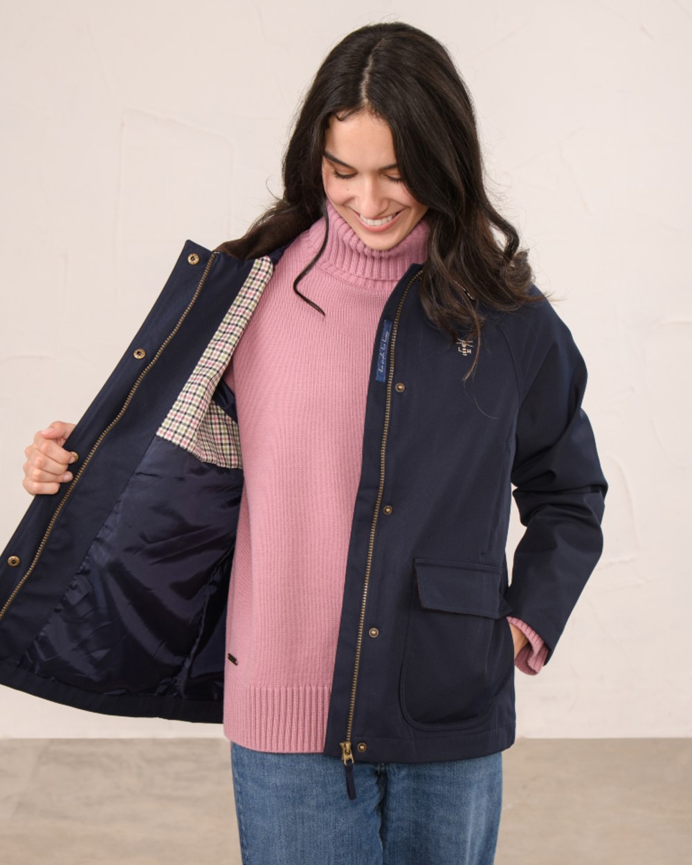 Navy coloured Lighthouse Ladies Devon Raincoat on indoor background 