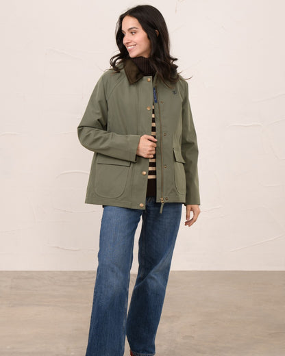 Olivine coloured Lighthouse Ladies Devon Raincoat on indoor background 