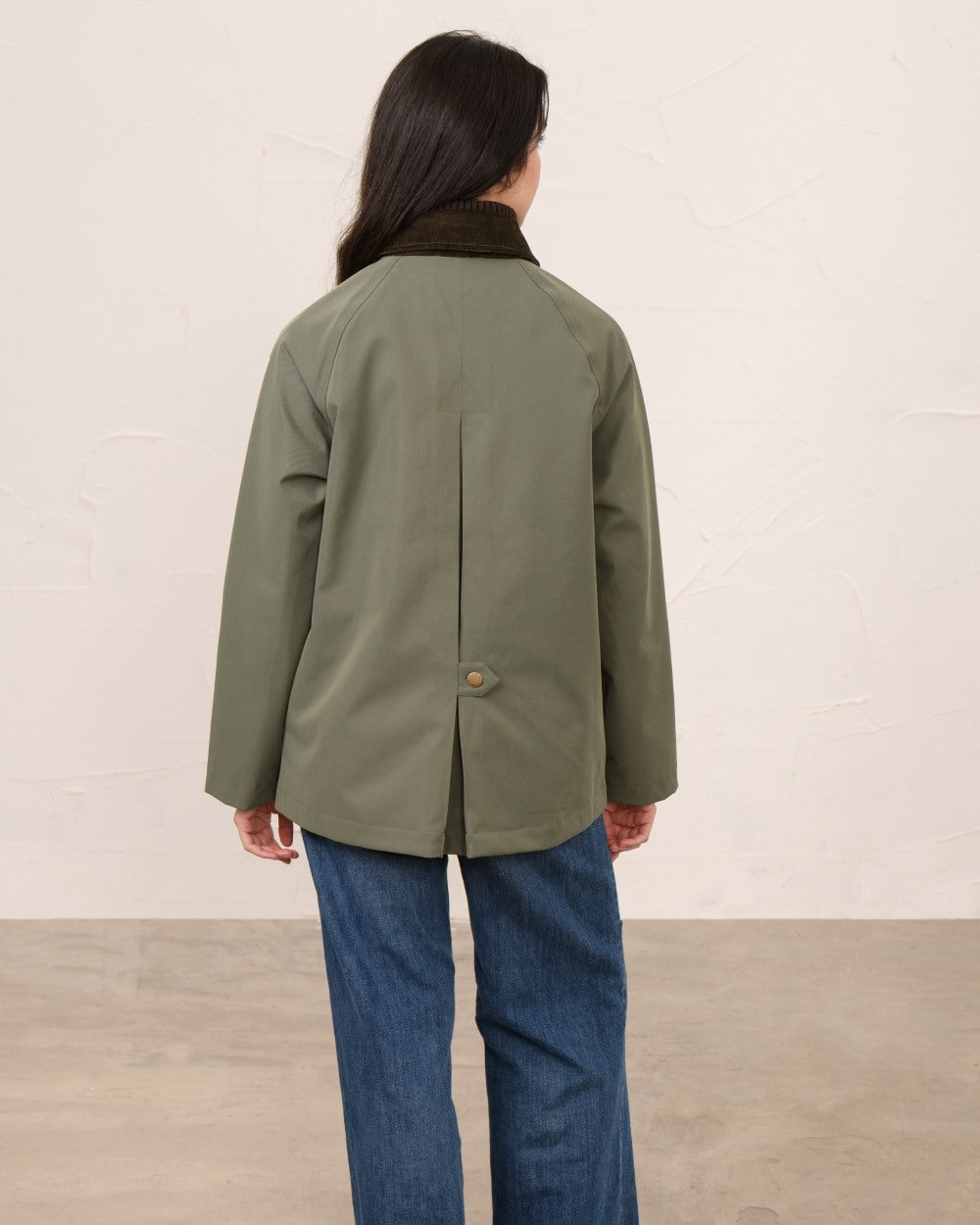 Olivine coloured Lighthouse Ladies Devon Raincoat on indoor background 