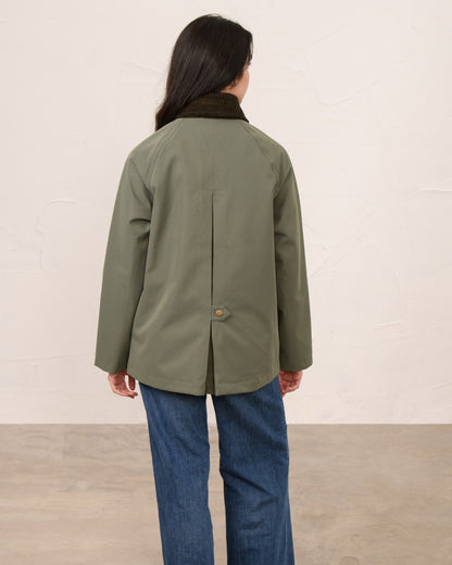 Olivine coloured Lighthouse Ladies Devon Raincoat on indoor background 